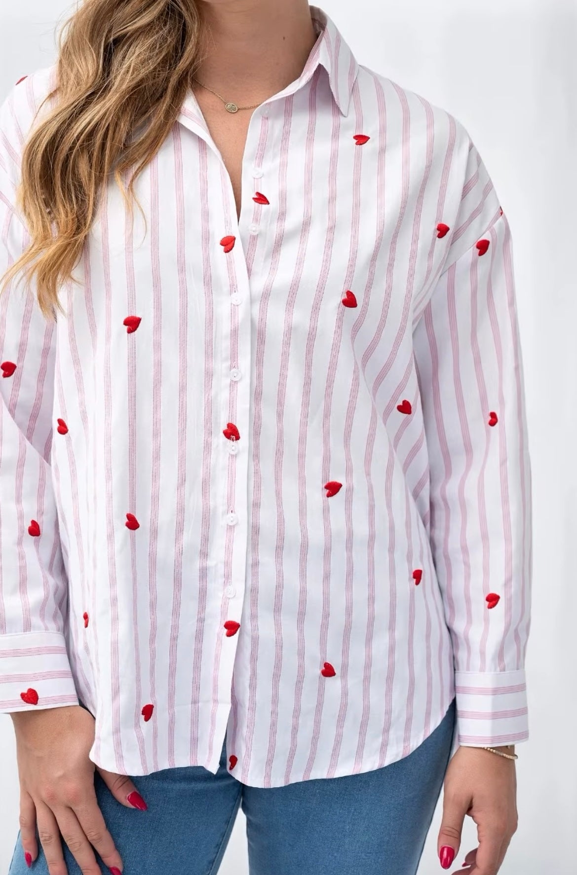 Pink striped shirt showing embroidered heart detail and collar