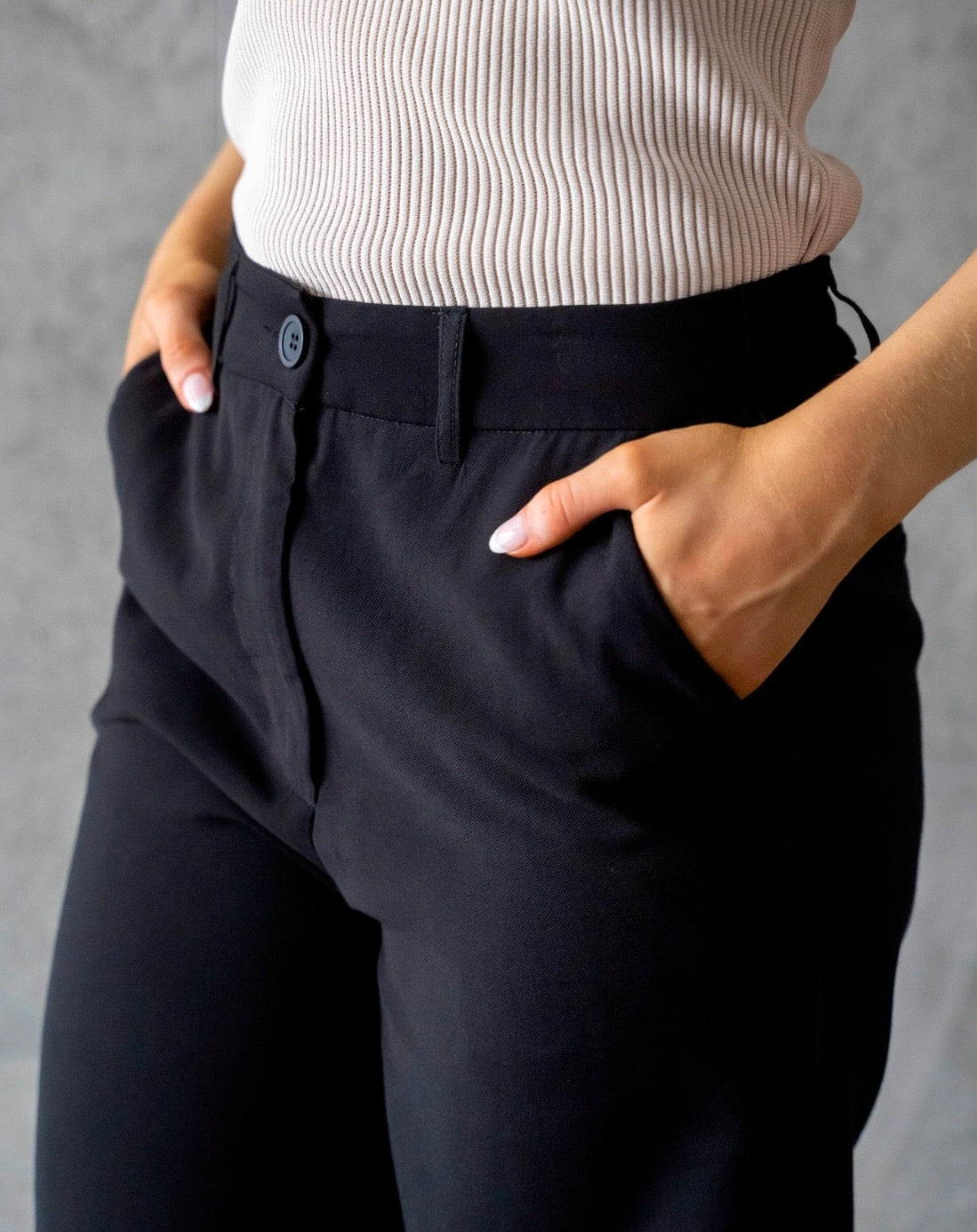 Navy wide leg pants showing relaxed fit and fly front detail