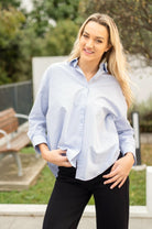 Pale blue 100% cotton collared shirt with hi-lo hem and relaxed fit