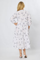 Midi length white cotton dress with elastic sleeve bands and tiered skirt