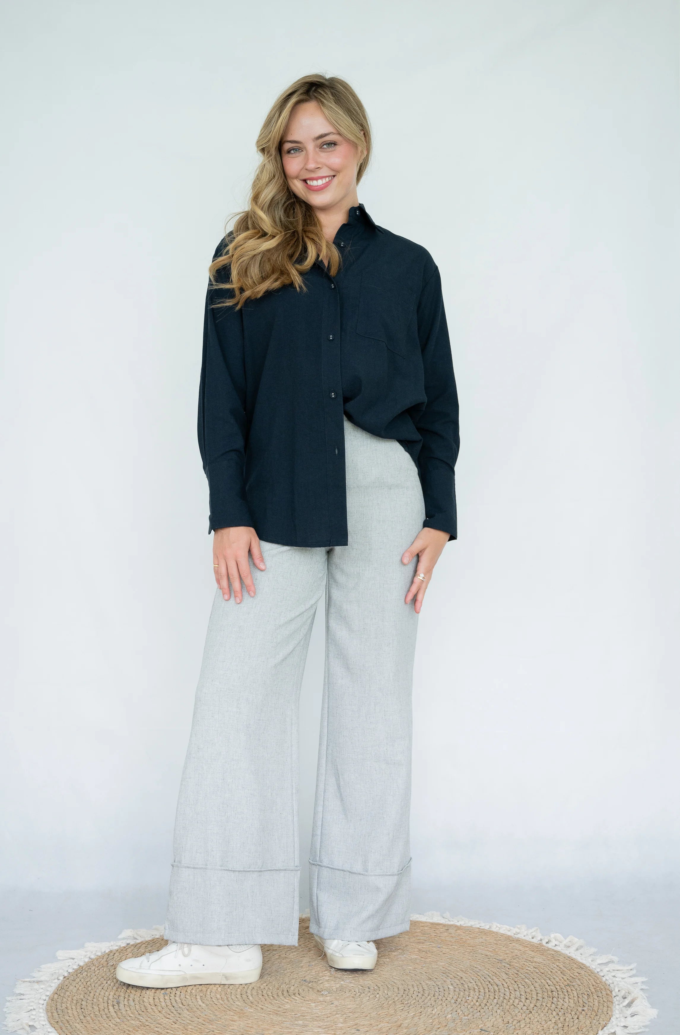 Navy blue collared shirt showing relaxed straight fit and curved hem