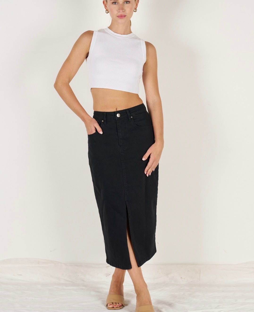 Black stretch denim midi skirt with front split and 5-pocket design